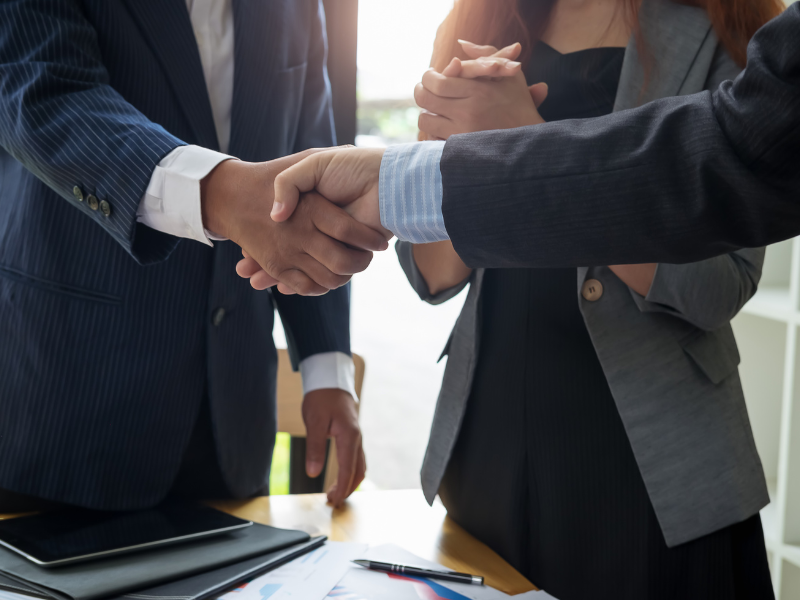 Bellingham Realtor shaking hands with clients after closing.