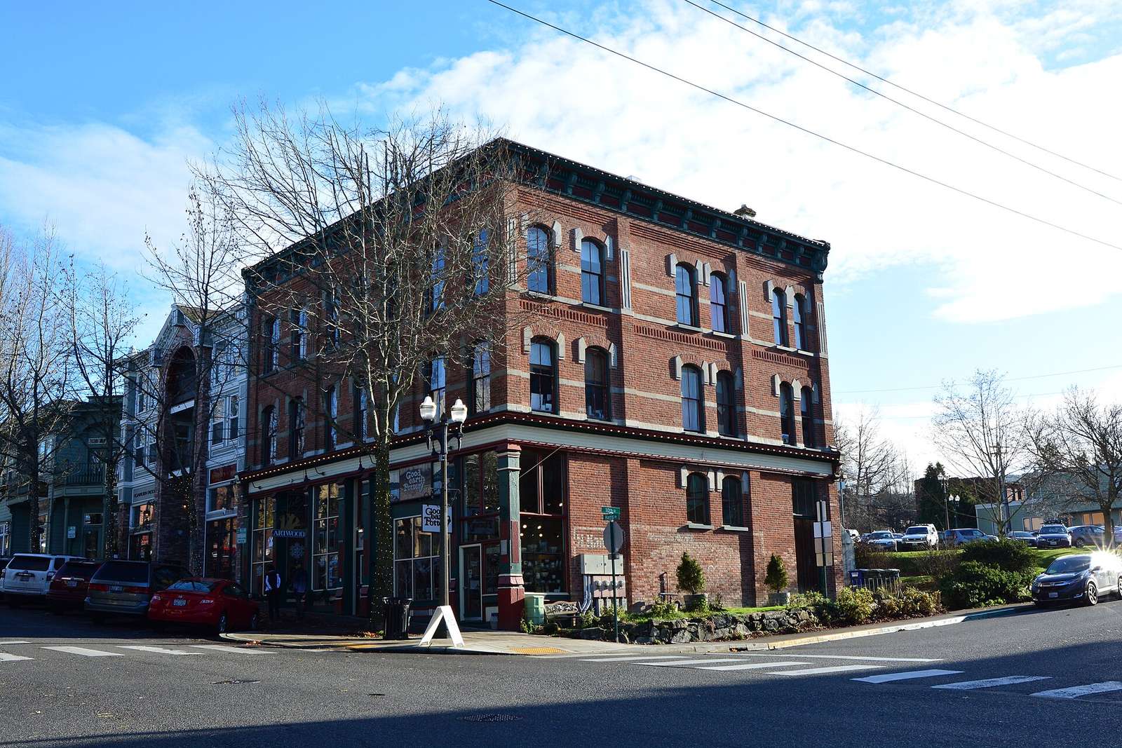Three-story red brick Morgan Block on a corner of Harris Avenue in Fairhaven under a blue sky
